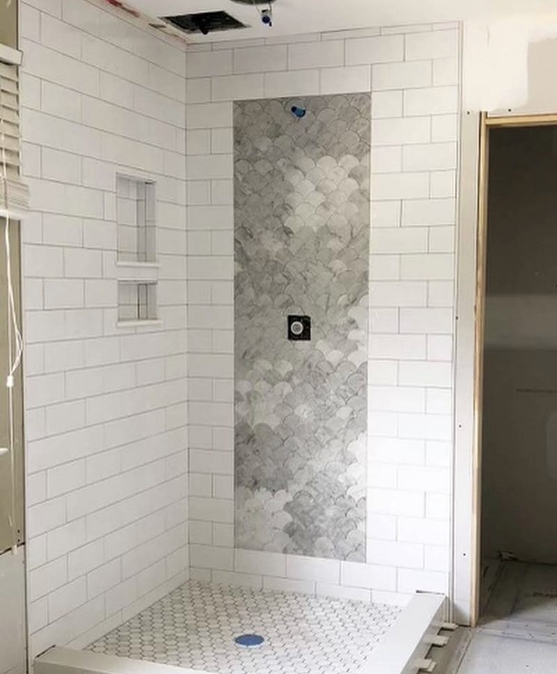 New tiled walk-in shower with white subway tile, fan-shaped accent panel and hex tile floor in a Western Massachusetts bathroom